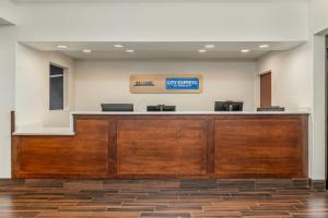 a lobby with a reception desk with a sign on the wall at City Express by Marriott Elkridge in Elkridge