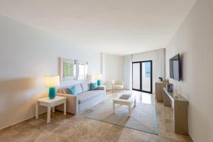 a living room with a couch and a table at Meliá Casa Maya Cancún in Cancún