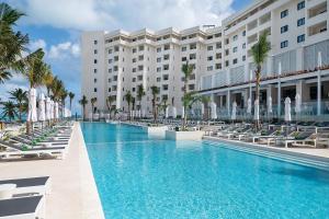 a swimming pool in front of a hotel at Meliá Casa Maya Cancún in Cancún +58 photos
