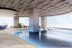 a pool with a fountain in the middle of a building at Meliá Aurea Nha Trang in Nha Trang