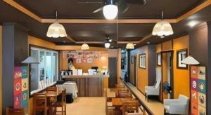 a restaurant with tables and chairs and a bar at Boracay Breeze Resort in Boracay