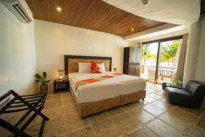 a bedroom with a bed with a teddy bear on it at Ambassador In Paradise in Boracay +148 photos