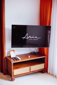 a flat screen tv sitting on top of a wooden table at Aria Exclusive Villas & SPA in Seminyak