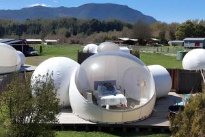a group of domes with a bed in a field at Open Sky Bubble for sleeping under the stars in Valparaíso