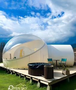 a glass dome house on a deck with chairs at Open Sky Bubble for sleeping under the stars in Valparaíso +34 photos
