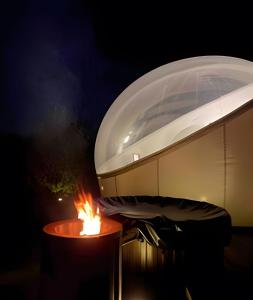 a grill with a fire in front of a building at Open Sky Bubble for sleeping under the stars in Valparaíso