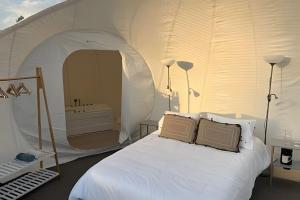 a bedroom with a tent with a bed and a tub at Open Sky Bubble for sleeping under the stars in Valparaíso