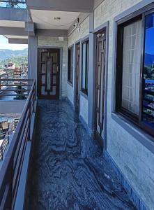a hallway of a house with a floor covered in water at Amigo Studio Inn Pokhara in Pokhara