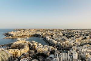an aerial view of a city with a harbor at ME by Meliá Malta in St. Julianʼs +94 photos