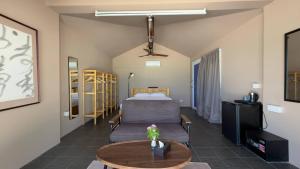 a bedroom with a bed and a table in a room at WHITE SAND ARK RESORT in Koh Rong Island