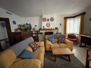 a living room with two couches and a table at Villa Herrero in La Adrada