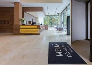an office lobby with a welcome mat on the floor at Meliá Düsseldorf in Düsseldorf
