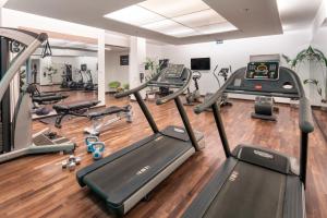 a gym with treadmills and elliptical machines at Meliá Düsseldorf in Düsseldorf +68 photos