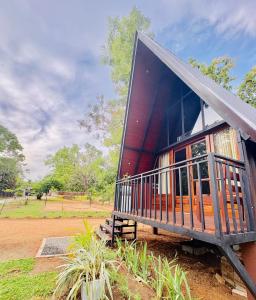 a house with a large porch on the side of it at Arcadiaa Cabana in Polonnaruwa
