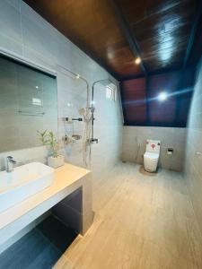 a bathroom with a sink and a toilet at Arcadiaa Cabana in Polonnaruwa