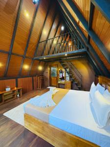 a large bed in a room with a wooden ceiling at Arcadiaa Cabana in Polonnaruwa