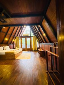 a large bedroom with a bed and a large window at Arcadiaa Cabana in Polonnaruwa