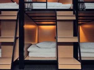a room with bunk beds with a bed in it at Seoul ABC Hostel in Seoul