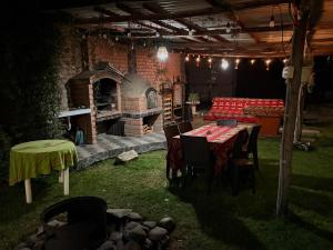 a patio with a table and a brick oven at Casa Munay in Huancayo