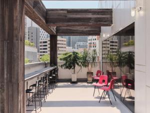 a balcony with chairs and tables on a building at Seoul ABC Hostel in Seoul