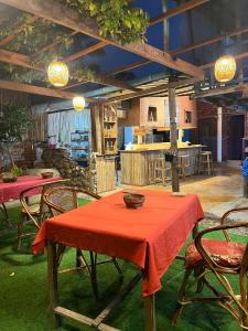 a dining room with tables and chairs with red table cloth at Setha About The World Home Stay & Restaurant in Battambang