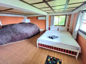 a bedroom with a large bed in a room at Magic View Apartments Koh Tao in Ko Tao