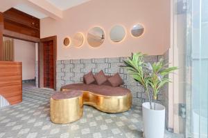 a living room with a couch and a table and mirrors at Hotel O Bhubaneswar New Station Road in Bhubaneshwar