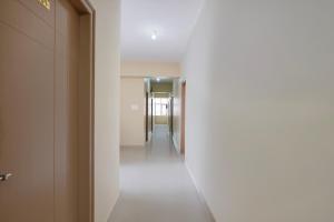 a hallway with a hallway leading into a building at Super Hotel O Phase 2 Christ Nagar Bangalore in Bangalore