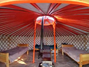 a yurt with two beds and a stove in it at Mongolian traditional Ger accomodation in Narst