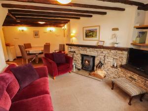 a living room with a couch and a fireplace at The Orchard in Kendal