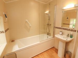 a bathroom with a shower and a tub and a sink at The Orchard in Kendal +22 photos