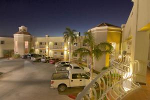 een hotel met auto's geparkeerd op een parkeerplaats bij Hotel Premier in Hermosillo