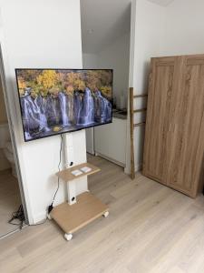 a flat screen tv on a wall in a living room at L'Escapade Caramanaise in Caraman