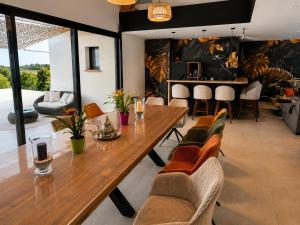a dining room with a large wooden table and chairs at L'Escapade Caramanaise in Caraman