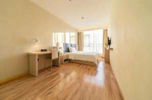 a bedroom with a bed and a desk and a window at Hanting Hotel Shanghai Wujiaochang in Shanghai +25 photos