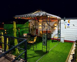 a patio with a gazebo and a table and chairs at Apart Hotel Caldera - Room in Caldera