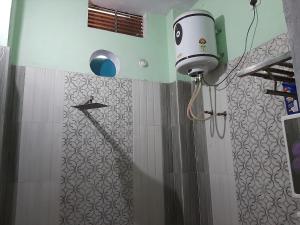 a shower with a blow dryer in a bathroom at SHYAMSHOBHA NIWAs in Chandauli