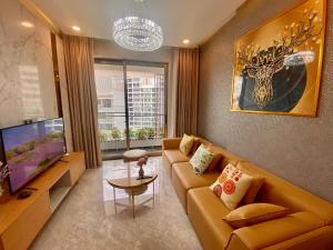 a living room with a couch and a tv at Premium Midtown serviced apartment in Ho Chi Minh City