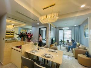a dining room and living room with a table at Premium Midtown serviced apartment in Ho Chi Minh City