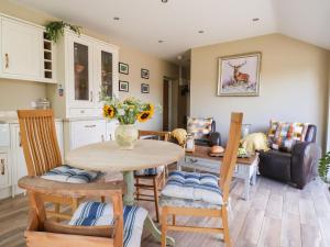 a kitchen and living room with a table and chairs at 1 Church Barns in Great Driffield