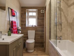 a bathroom with a toilet and a shower and a sink at 1 Church Barns in Great Driffield +27 photos