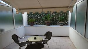a table and chairs on a balcony with plants at Residence Club Inn in Nice