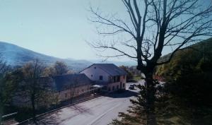a large white house in the middle of a road at Rooms Putnik in Senj