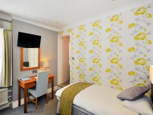 Ένα ή περισσότερα κρεβάτια σε δωμάτιο στο Ardington Hotel