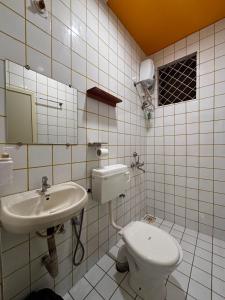 a bathroom with a sink and a toilet at Horn Ok Please Hostel Mandrem in Mandrem +40 photos