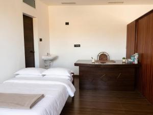 a bedroom with two beds and a sink in it at Tranquil Tents in Trivandrum