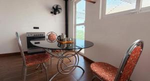 a kitchen with a table and chairs and a window at Tranquil Tents in Trivandrum