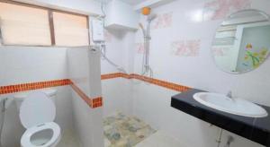a bathroom with a toilet and a sink and a mirror at Jirawan Hotel in Ko Samed +220 photos