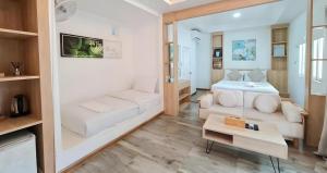 a small living room with a bed and a couch at Sawasdee Coco Resort in Ko Samed
