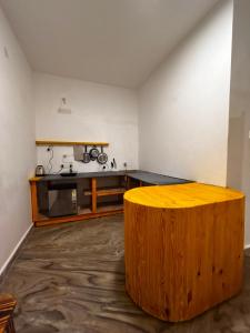 a room with a large wooden table in a room at Horn Ok Please Hostel Mandrem in Mandrem